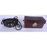AN ANTIQUE BROWN LEATHER CASED TRAVELLING KIT together with three other leather boxes & a camera. (