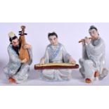 THREE CHINESE PORCELAIN FIGURINES OF MUSICIANS, modelled in various poses. Largest 23.5 cm. (3)