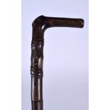 AN EARLY 20TH CENTURY RHINOCEROS HORN HANDLED WALKING STICK, formed imitating bamboo, with a natura