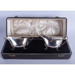 A CASED PAIR OF SILVER SAUCEBOATS. Birmingham 1932. 6 oz. 14 cm wide.
