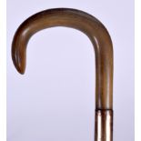 A GOOD LATE 19TH CENTURY RHINOCEROS HORN HANDLED WALKING CANE, formed with a yellow metal collar.