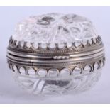 AN 18TH/19TH CENTURY SILVER MOUNTED ROCK CRYSTAL PILL BOX carved with motifs. 4.75 cm wide.