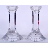 A PAIR OF ORREFORS GLASS CANDLESTICKS, formed with heavy splayed bases, signed. 20 cm high.