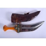 A 19TH CENTURY ISLAMIC AMBER STYLE OMANI JAMBIYA DAGGER inset with four gold coins. 32 cm long.