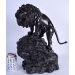 A LARGE 19TH CENTURY JAPANESE MEIJI PERIOD BRONZE OKIMONO modelled as a lion upon a naturalistic ba