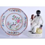 A 19TH CENTURY STAFFORDSHIRE FIGURE OF UNCLE TOM & EVA together with a Staffordshire plate. (2)