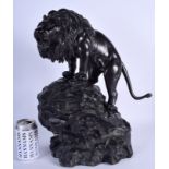 A LARGE 19TH CENTURY JAPANESE MEIJI PERIOD BRONZE OKIMONO modelled as a lion upon a naturalistic bas