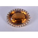 A VICTORIAN GOLD PEARL AND TOPAZ BROOCH. 2 cm x 2 cm.