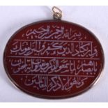 AN ANTIQUE MIDDLE EASTERN ISLAMIC CALLIGRAPHY PENDANT. 4.5 cm x 3.5 cm.