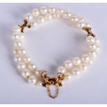 A GOLD AND DOUBLE PEARL STRAND BRACELET. 14 cm long.