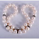 AN 18CT GOLD AND DIAMOND PEARL NECKLACE. 40 cm long.