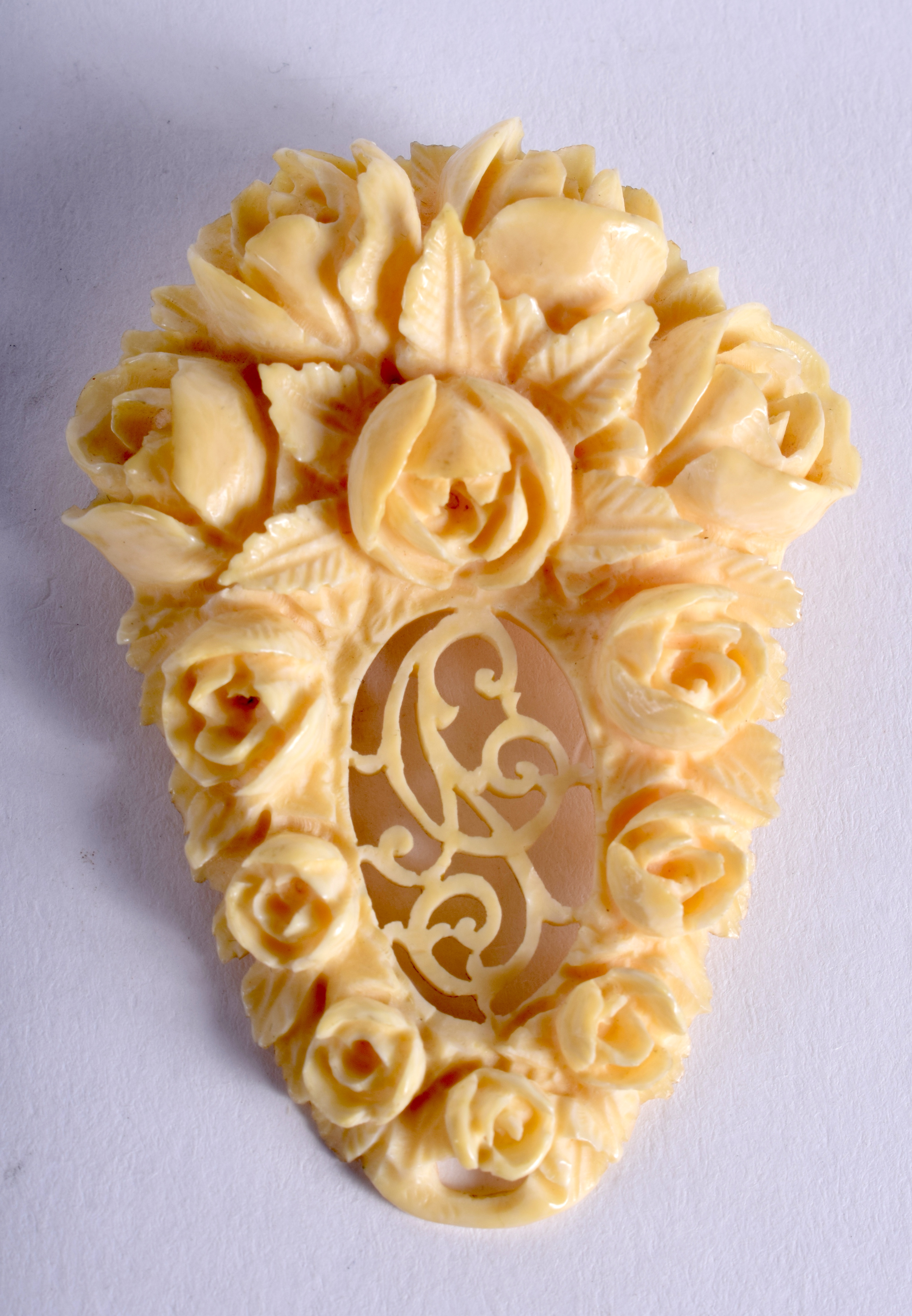 AN ANTIQUE CARVED IVORY BROOCH. 6 cm x 4 cm.