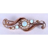 A VICTORIAN 15CT GOLD AND OPAL BROOCH. 2.1 grams. 3.5 cm wide.