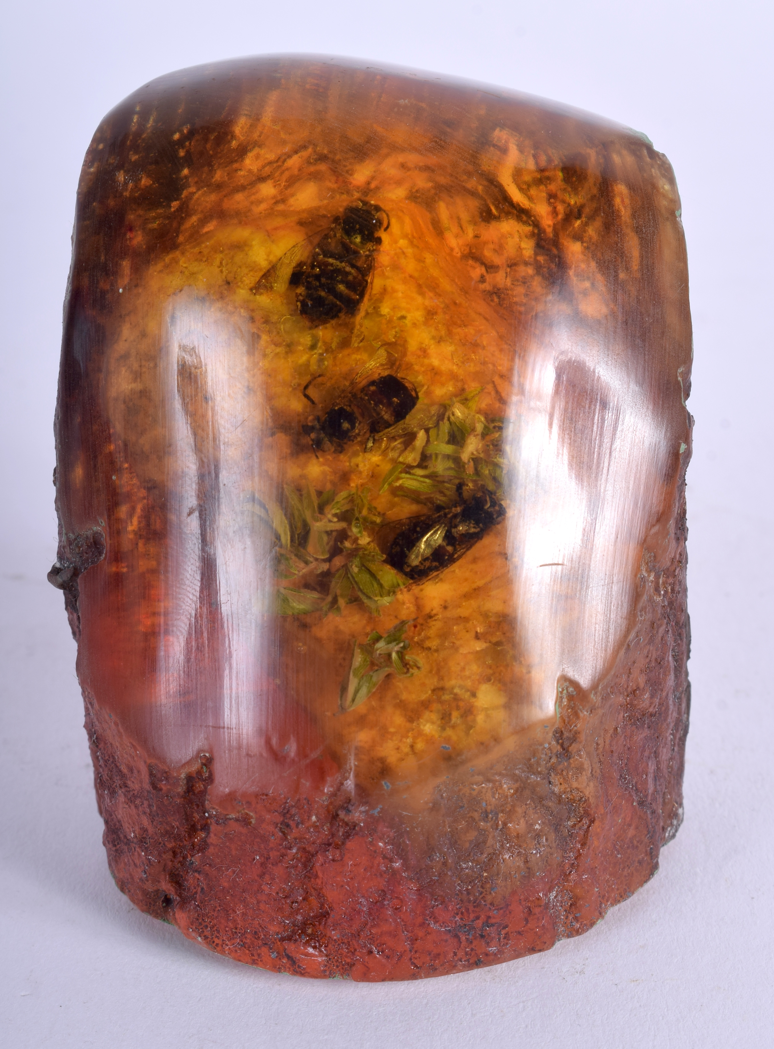 A CARVED AMBER SPECIMEN. 7 cm x 5.5 cm.