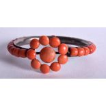 AN ANTIQUE SILVER AND CORAL BANGLE. 7.5 cm wide.