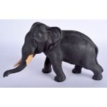 A 19TH CENTURY JAPANESE MEIJI PERIOD BRONZE OKIMONO modelled as a roaming elephant. 23 cm x 18 cm.