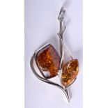 A LARGE SILVER AND AMBER PENDANT.