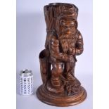 A RARE 19TH CENTURY BAVARIAN BLACK FOREST FIRE LIGHT HOLDER formed as a standing roaming gnome. 44 c