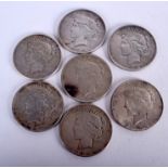 SEVEN VINTAGE SILVER DOLLAR COINS. (7)