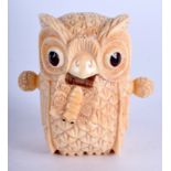 A NOVELTY OWL BONE TAPE MEASURE. 5.5 cm x 3.5 cm.