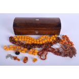 A VICTORIAN BOX together with amber necklaces. (qty)