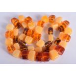 A 1950S AMBER NECKLACE. 80 cm long.