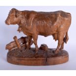 A 19TH CENTURY BAVARIAN BLACK FOREST FIGURE OF A COW modelled upon a naturalistic base. 28 cm x 23 c