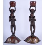 A PAIR OF 19TH CENTURY JAPANESE MEIJI PERIOD BRONZE CANDLESTICKS formed as standing apes.