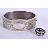 A VINTAGE SILVER BANGLE together with a silver ring. (2)