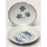 TWO CHINESE PORCELAIN SHALLOW DISHES of plain circular form, painted in underglaze blue, one with