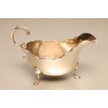 A SILVER SAUCE BOAT, maker's mark WG & S, Birmingham 1940, the shaped oval bowl with cast and