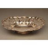 A LATE GEORGE III SILVER BASKET, maker Kirkby, Waterhouse & Co., Sheffield 1819, of lobed oval form,