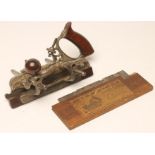 A STANLEY NO 45 PLOUGH PLANE with rosewood handle and knob, 11" wide overall, together with a