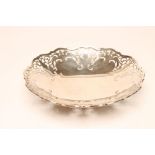 A SILVER FRUIT DISH, maker Viners, Sheffield 1933, of shaped circular form with pierced scroll