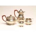 A SILVER FOUR PIECE TEA AND COFFEE SERVICE, maker Adie Bros. Ltd., Birmingham 1941, of squat