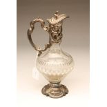 AN EPNS MOUNTED CLEAR GLASS CLARET JUG, the baluster body with diamond, panel and printe cutting,