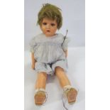 A mid 20th century German composition walking doll with blue glass sleeping eyes, open mouth and