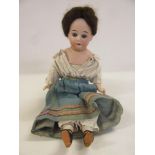 A Cuno & Otto Dressel bisque shoulder head doll, with fixed blue glass eyes, open mouth and teeth,