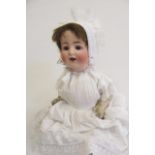 An Alt Beck & Gottschalck bisque head doll with brown glass sleeping eyes, open mouth and teeth,