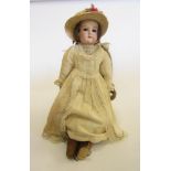 An Armand Marseille bisque shoulder head doll with brown glass sleeping eyes, open mouth and