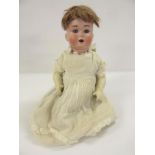 A Schutzmeister & Quendt bisque head doll, with blue glass sleeping eyes, open mouth and teeth, pale