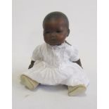 An Armand Marseille Mulatto baby doll with brown glass sleeping eyes, closed mouth, composition bent