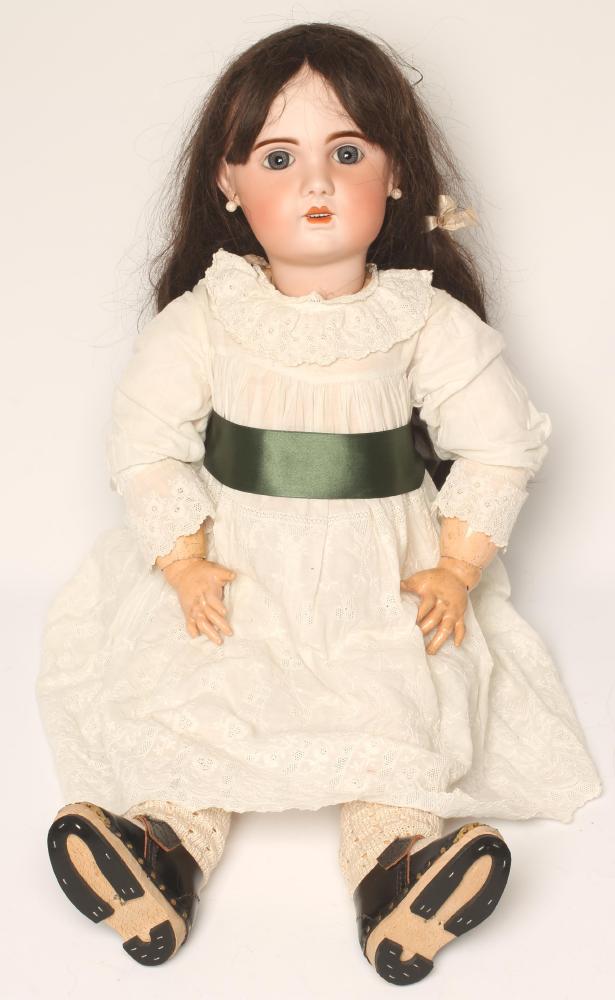 A Tete Jumeau bisque head doll with fixed blue paperweight glass eyes, open mouth and teeth, pierced