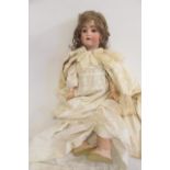 An Alt Beck & Gottschalck bisque head doll with blue glass sleeping eyes, open mouth and teeth,