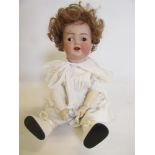 A Kammer & Reinhardt bisque head character doll, with brown glass flirty eyes, open mouth, teeth and