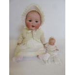 An Armand Marseille bisque head baby doll, with blue glass sleeping eyes, open mouth and teeth,