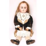 A French Bebe bisque head doll with fixed blue paperweight glass eyes, open mouth and teeth, pierced