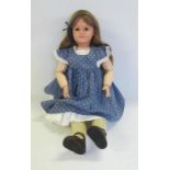 A French all composition doll with fixed brown glass eyes, painted mouth, later brown mohair wig,