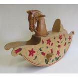 A slab sided rocking horse by Anthony Dew, plywood construction, with painted flowers, solid wood