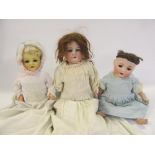 An Armand Marseille bisque shoulder head doll with blue glass sleeping eyes, open mouth and teeth,